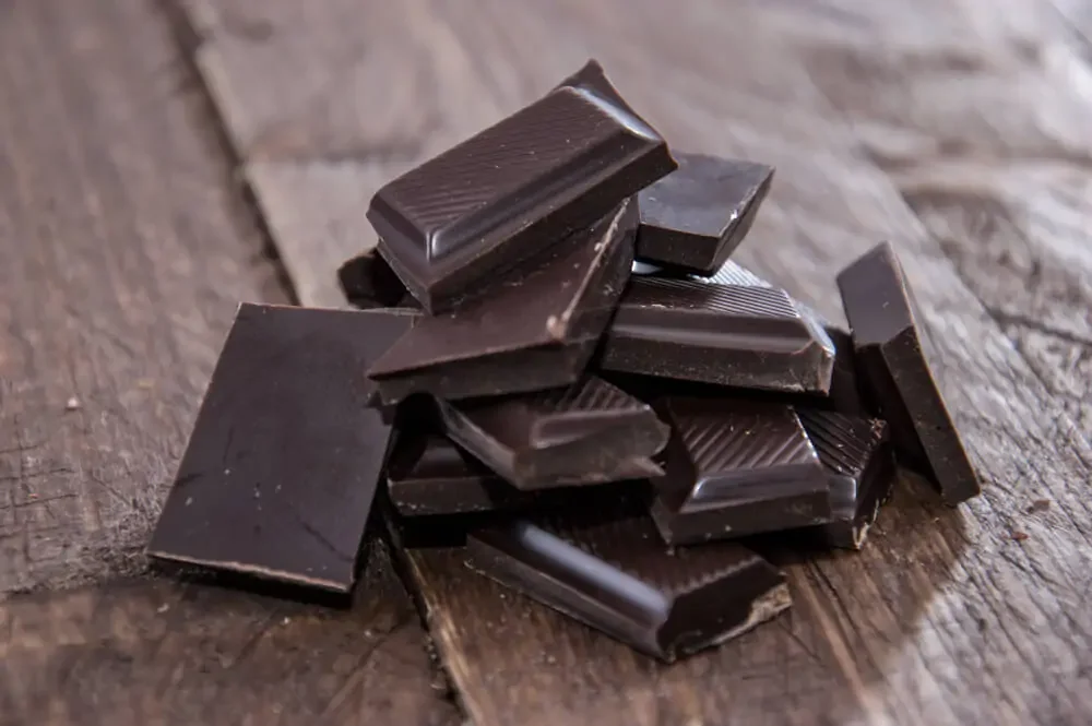 pile of vegan dark chocolate on a wooden table