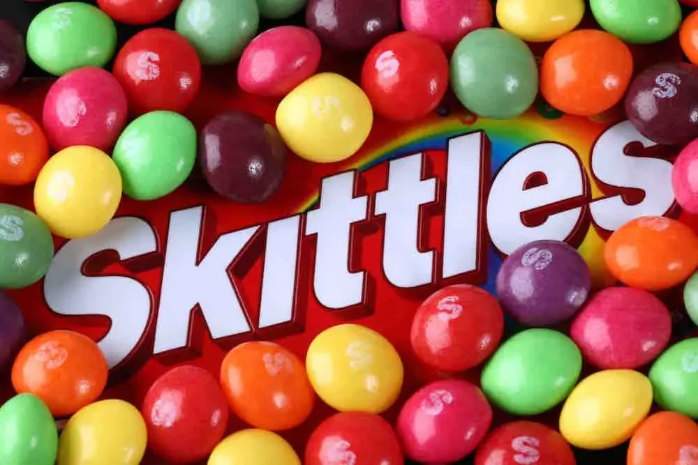 box of skittles surrounded by the fruit candy