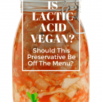 kilner jar full of bright orange kimchi against a white background with the text, "is lactic acid vegan?" overlaid in a text box.