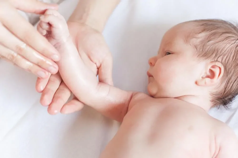 the best baby lotion being rubbed into an infant's arm