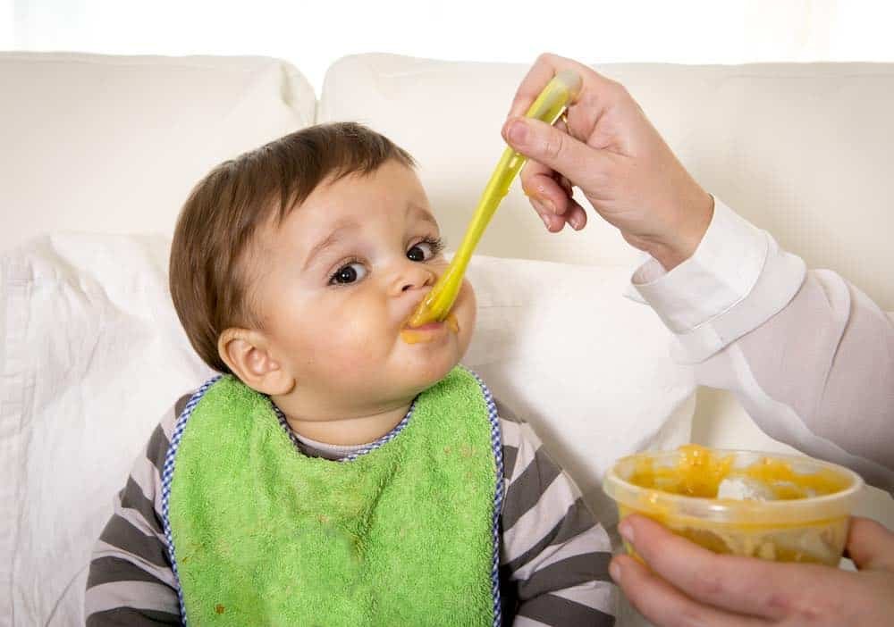 best baby bib being worn by an infant during feeding time