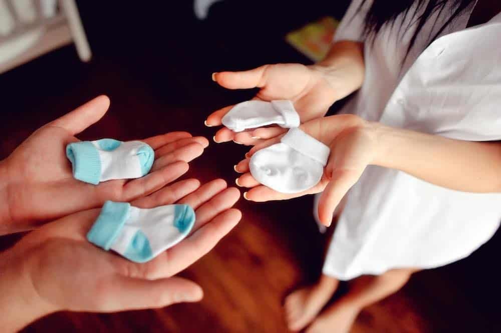 organic cotton baby socks in parents hands